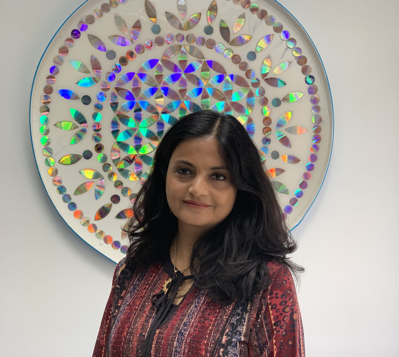 Sejal Joshi in front of one of her recycled DVD mandalas